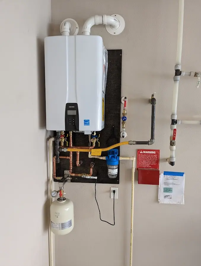 Professional plumber installing copper piping in a St. John home